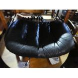 Black leather reclining footstool on chrome supports