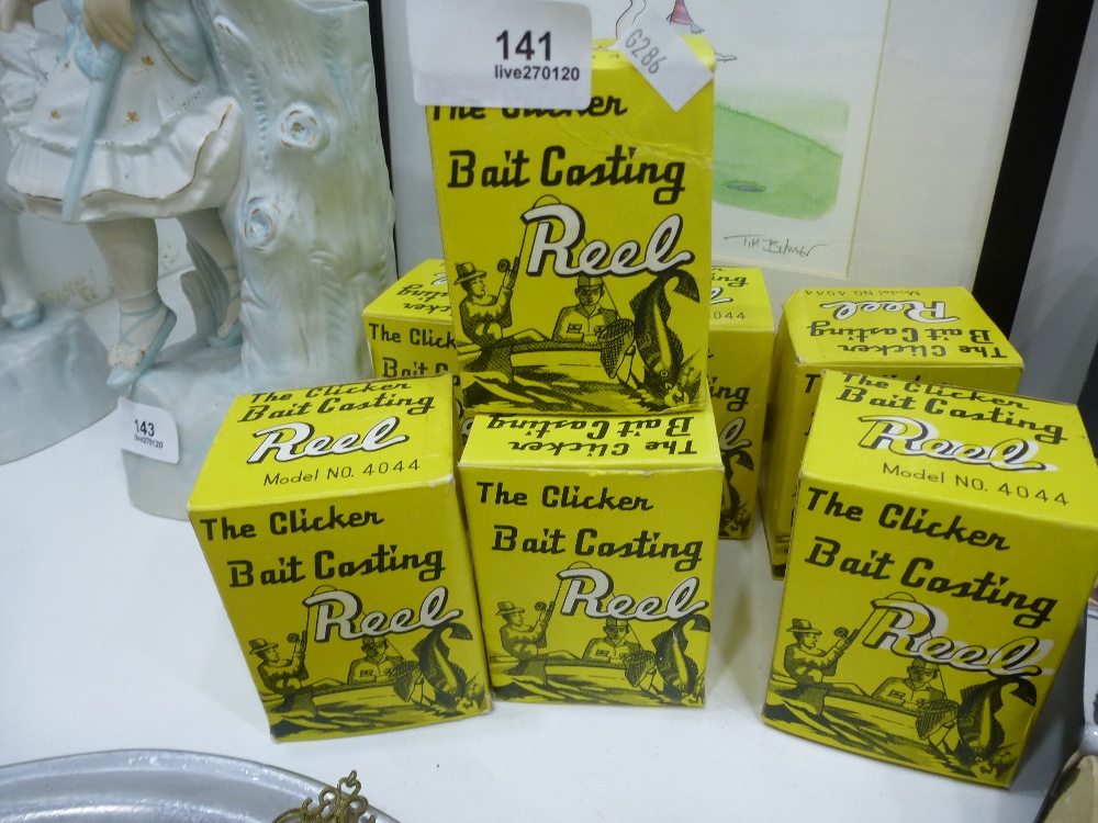 Seven small boxed fishing reels.