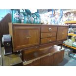 Mid-century teak sideboard with three central drawers framed by cupboards