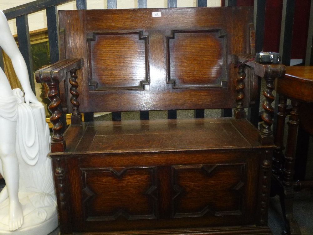 A 1930's oak monks bench with barley twist supports