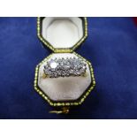 Modern 3 stone diamond cluster ring with smaller diamonds surrounded on an 18ct yellow and white