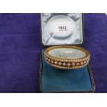 Victorian yellow coloured metal hinged bangle half set with pearls set with pearls & small beads