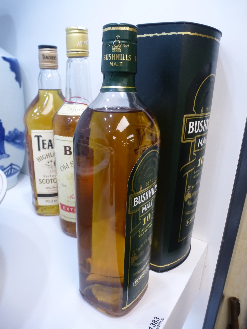 A bottle of Bushmills Irish Whiskey 700ml and a bottle of Teachers and a bottle of Bells