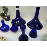 A pair of Bristol blue decanters and five other similar items.