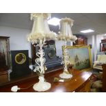 A pair of modern table lamps with scroll decoration.