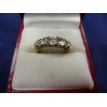 Five stone graduated diamond ring on a yellow coloured metal shank, unmarked size N, gross item