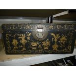 An antique black leather trunk having impressed Chinese gilt decoration.