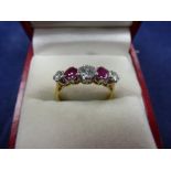 Five stone diamond and ruby ring on an 18ct yellow gold and platinum shank, stamped 18ct & PLAT,