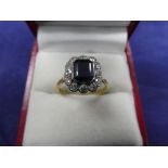 Sapphire and diamond ring on an 18ct yellow gold and platinum shank, stamped 18ct and PLAT, size