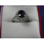 Sapphire and diamond cluster style ring on an 18K white gold shank, stamped 18K, size M, gross