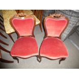 A pair of Victorian Rosewood bedroom chairs with carved decoration and padded backs