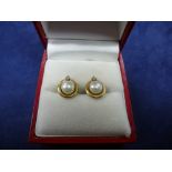Pair of cultured pearl and diamond chip ear studs set in 14K yellow gold, stamped 14K, gross