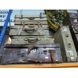 Six vintage suitcases of various sizes, to include military styles