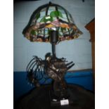 An Art Deco lamp in the form of a ballerina with a Tiffany style shade