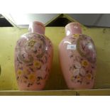 A pair of decorative pink flower vases