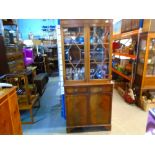 A reproduction glass dish cabinet over two drawers and two doors