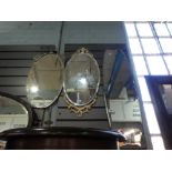 Three frameless bevelled wall mirrors