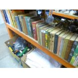 Half a shelf of hardbook books and annuals