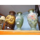 Two decorative green vases with painted flowers and a glazed larger brown vase