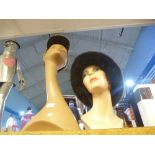 Two mannequin heads with hats