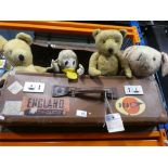 Vintage suitcase containing collection of old teddy bears