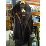 Two dark brown knee length fur coats serviced by Victor Segall, London Furriers