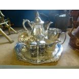 A silver plate tray with teapot, cream jug, salt and pepper, etc