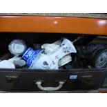 A suitcase of mixed items including a blue and white ginger jar, ceramic jugs, porcelain lamp, etc