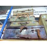 Six vintage suitcases of various sizes, to include military styles