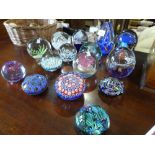 Collection glass paperweights including Caithness examples and basket hardstone eggs