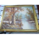 An oil painting in a gilt frame depicting a woodland scene along with a wooden box