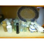 Blue and white charger plates, glass and earthenware bottles, English willow jugs, Wedgewood vase,