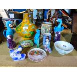 A selection of oriental items to include two vases, male and female figures, pair of blue birds,