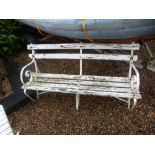 A vintage weathered garden bench comprising metal and wood