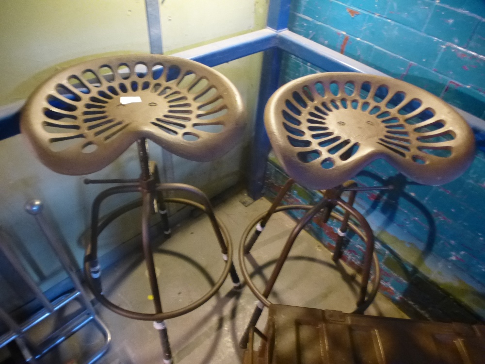 A pair of tractor seat stools