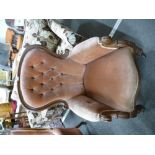A Victorian mahogany buttonback armchair having pink dralon upholostery