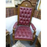 A 20th century oak 'Judges' open armchair having red leather buttoned upholostery