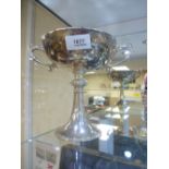 A silver bowl of shallow proportion on an ornate circular base and decorative handles hallmarked