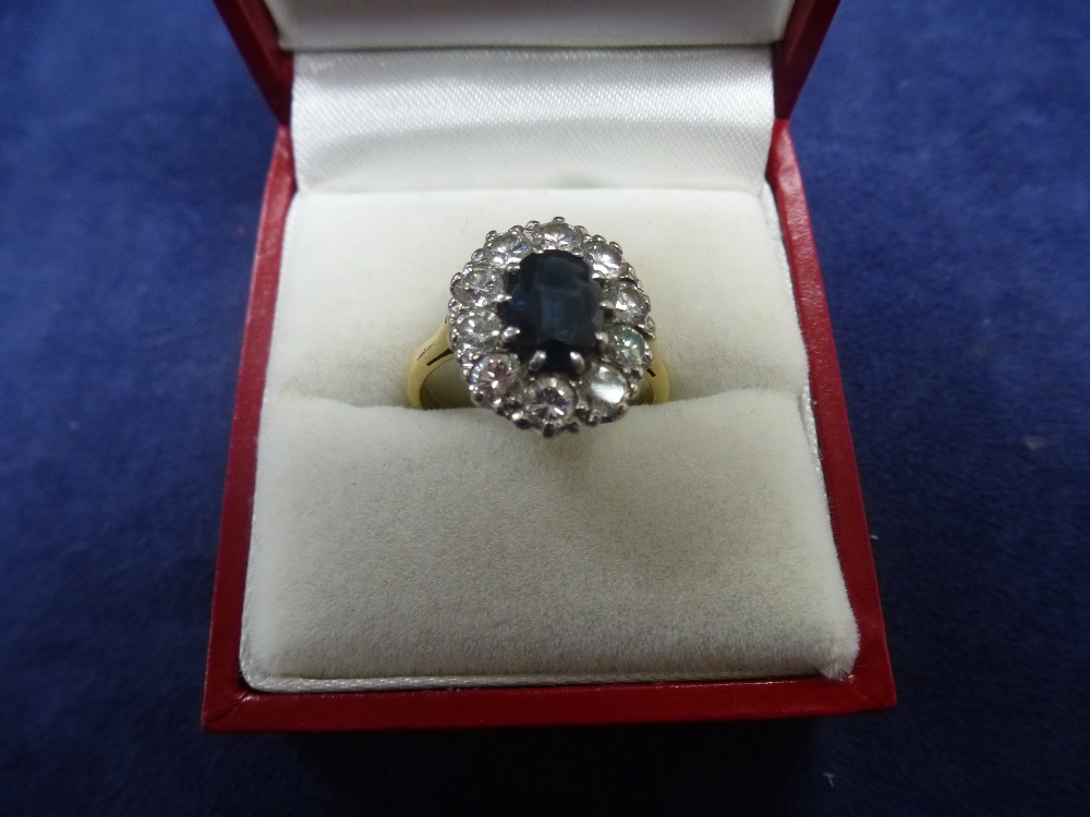 Sapphire and diamond cluster style ring on an 18ct yellow gold and platinum shank, stamped N gross