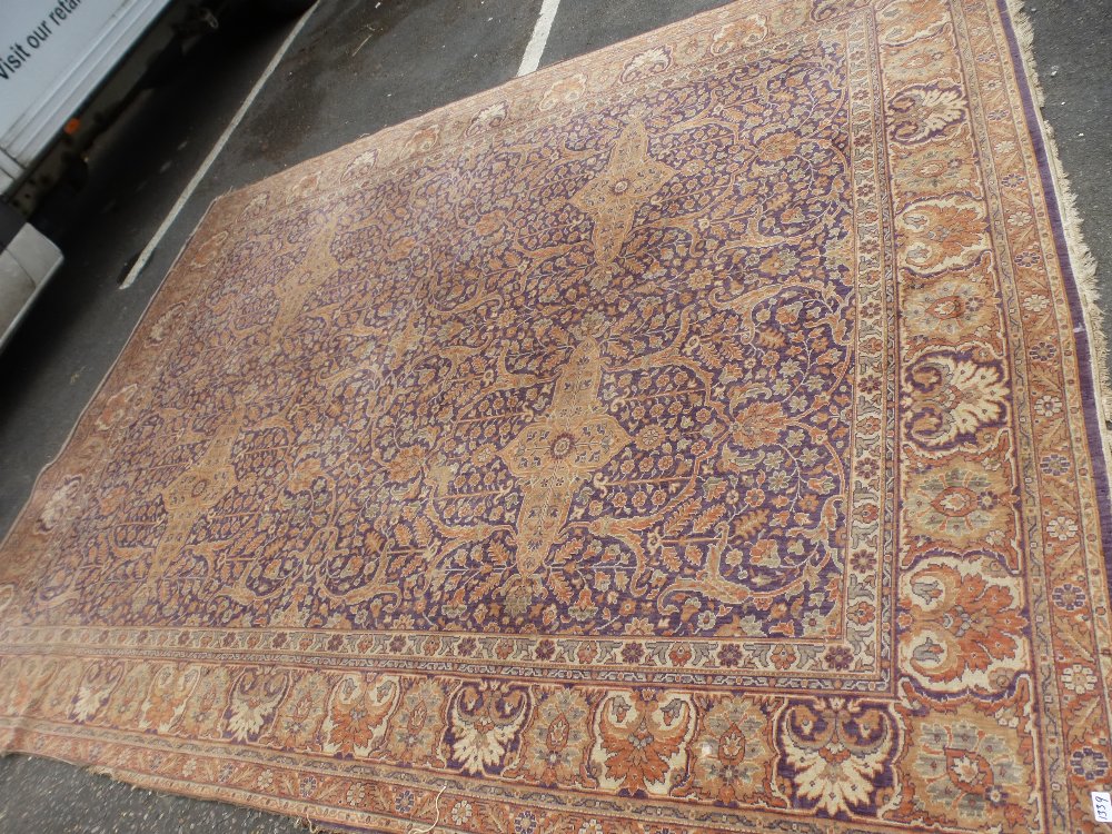 An early 20th century Persian carpet having all over floral design, blue bordered, 373 x 325 cms and