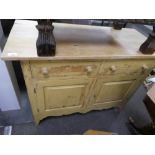 A painted pine cupboard having two drawers, 111.5cms