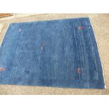 A modern Gabbeh blue ground rug, decorated stylised animals, 209 x 151 cms