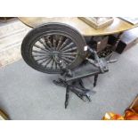 An antique oak spinning wheel, the base having inscription regarding the wheel belonging to a family