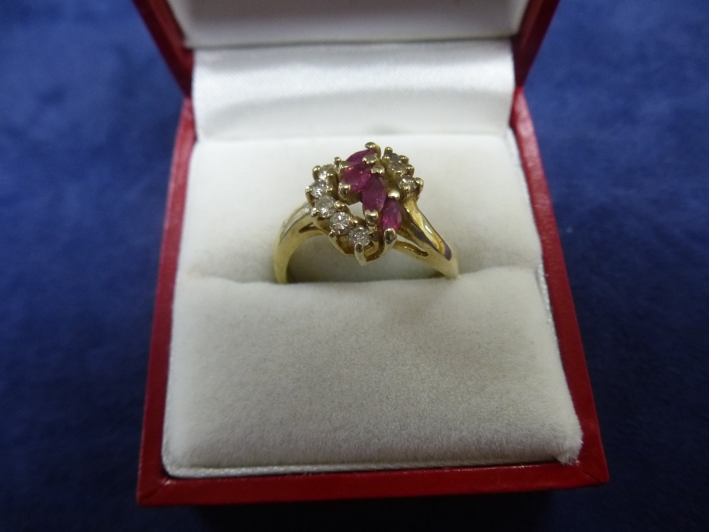 Yellow metal dress ring set with diamond chips and rubies, size O