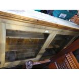 An old stripped pine hanging book case with pair of glazed doors, 126 cms