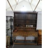 A Reproduction oak dresser and rackback having five drawers, 157 cms