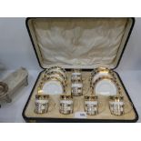 An Aynsley coffee set for six in fitted case, the coffee cans having silver pierced holders by
