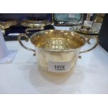 A silver sugar bowl of plain design with two ornate handles dated to the base 1896, Weight 4.6oz,