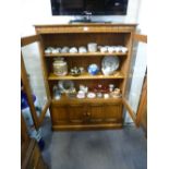 An Ercol oak two door display cabinet with cupboard below