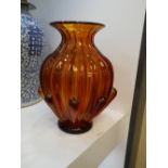 A mid 20th century orange glass vase with ribbed decoration, 29cms